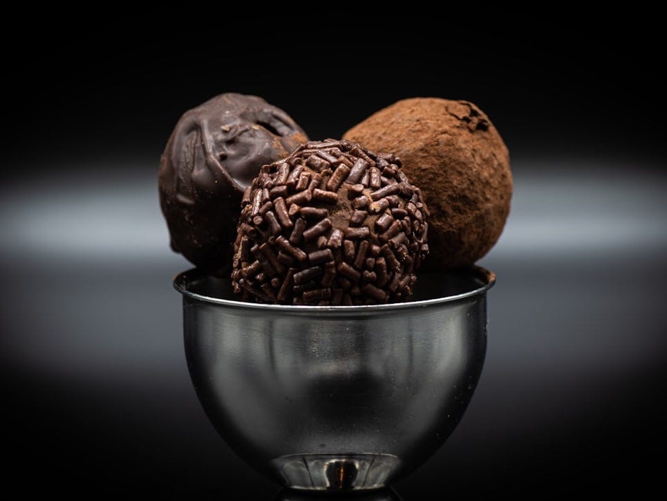 a metal bowl filled with different types of chocolates