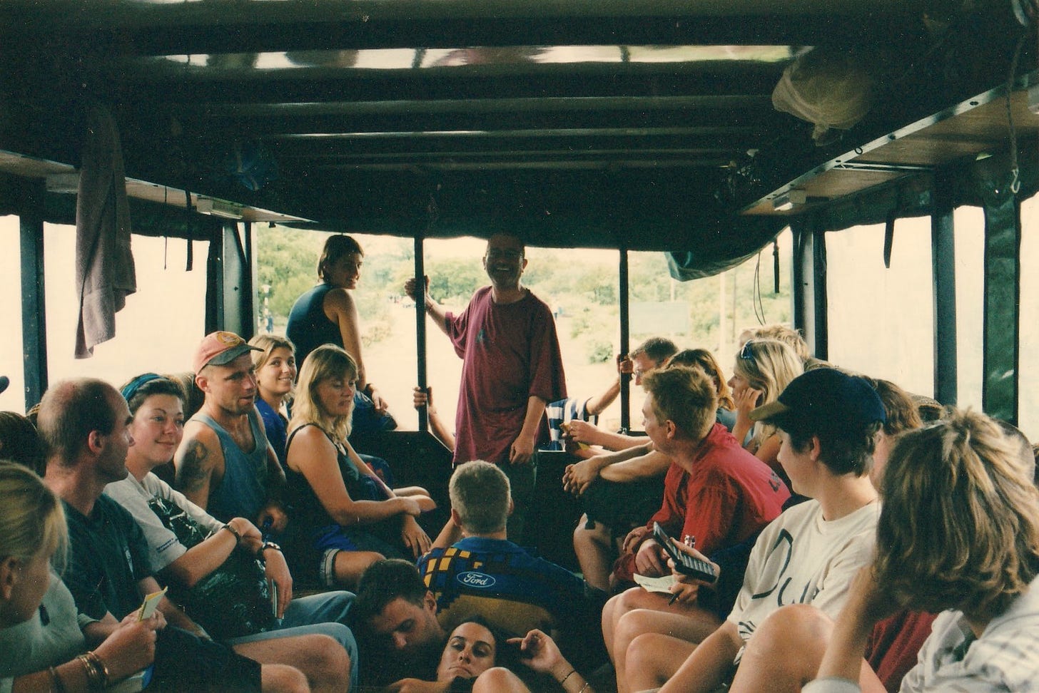 People on an open-sided bus in South Africa