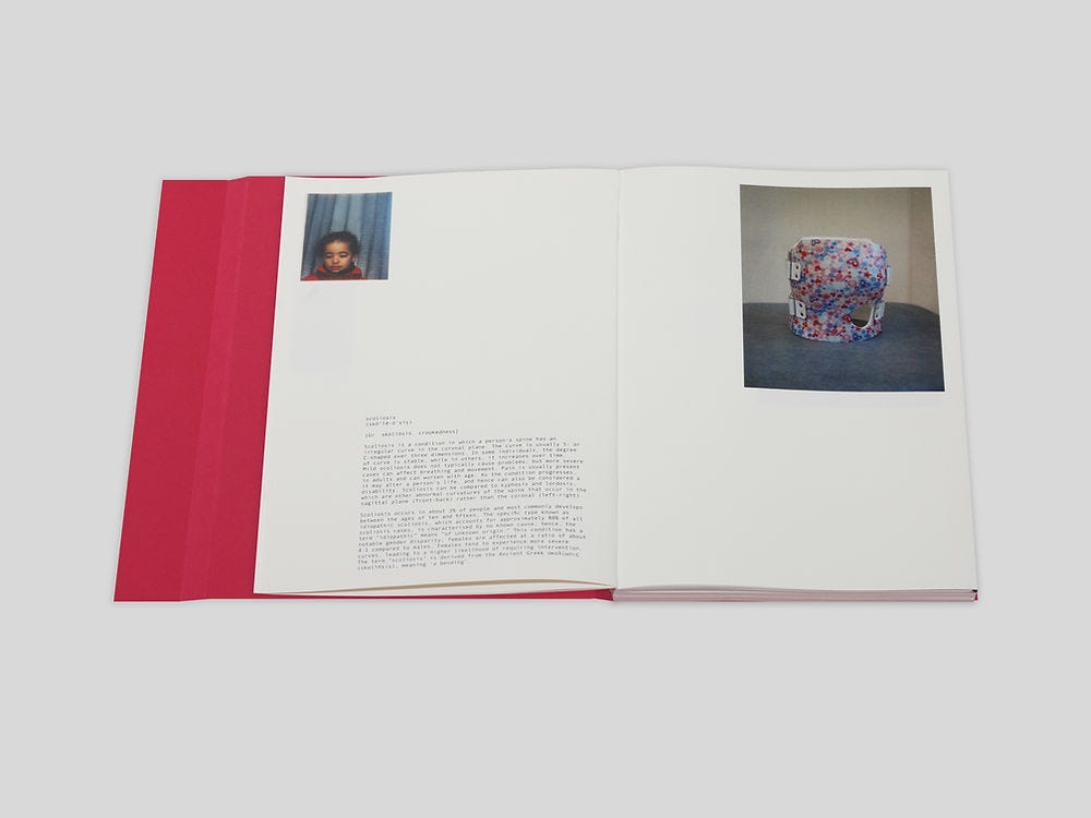 A book open to a page with small text, a photo of a child, and a photo of a multi-colored sculptural artwork.