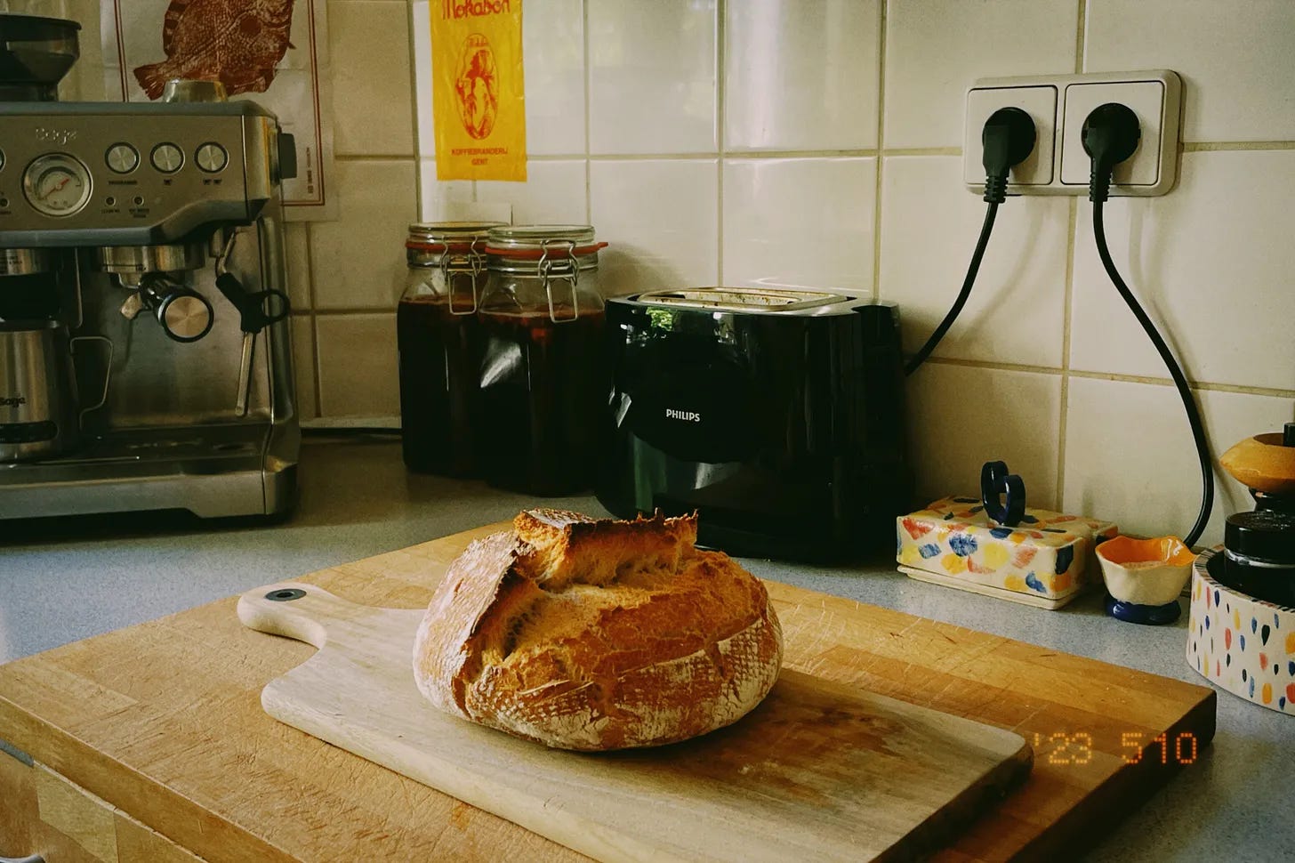 a loaf of sourdough bread resting on a kitchen counter