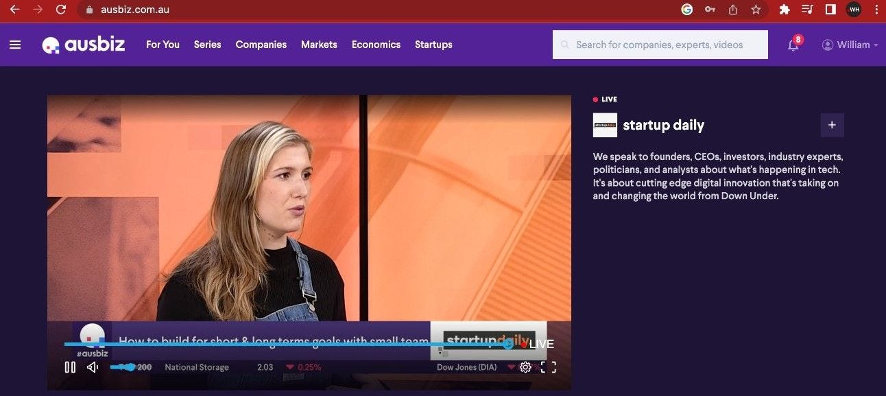 A browser showing ausbiz website with a media player showing a live stream, Kayla is on the screen