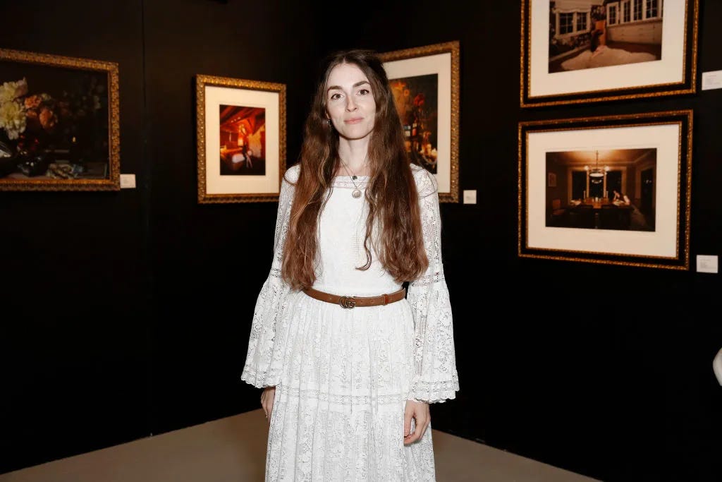 anna marie tendler in front of her art