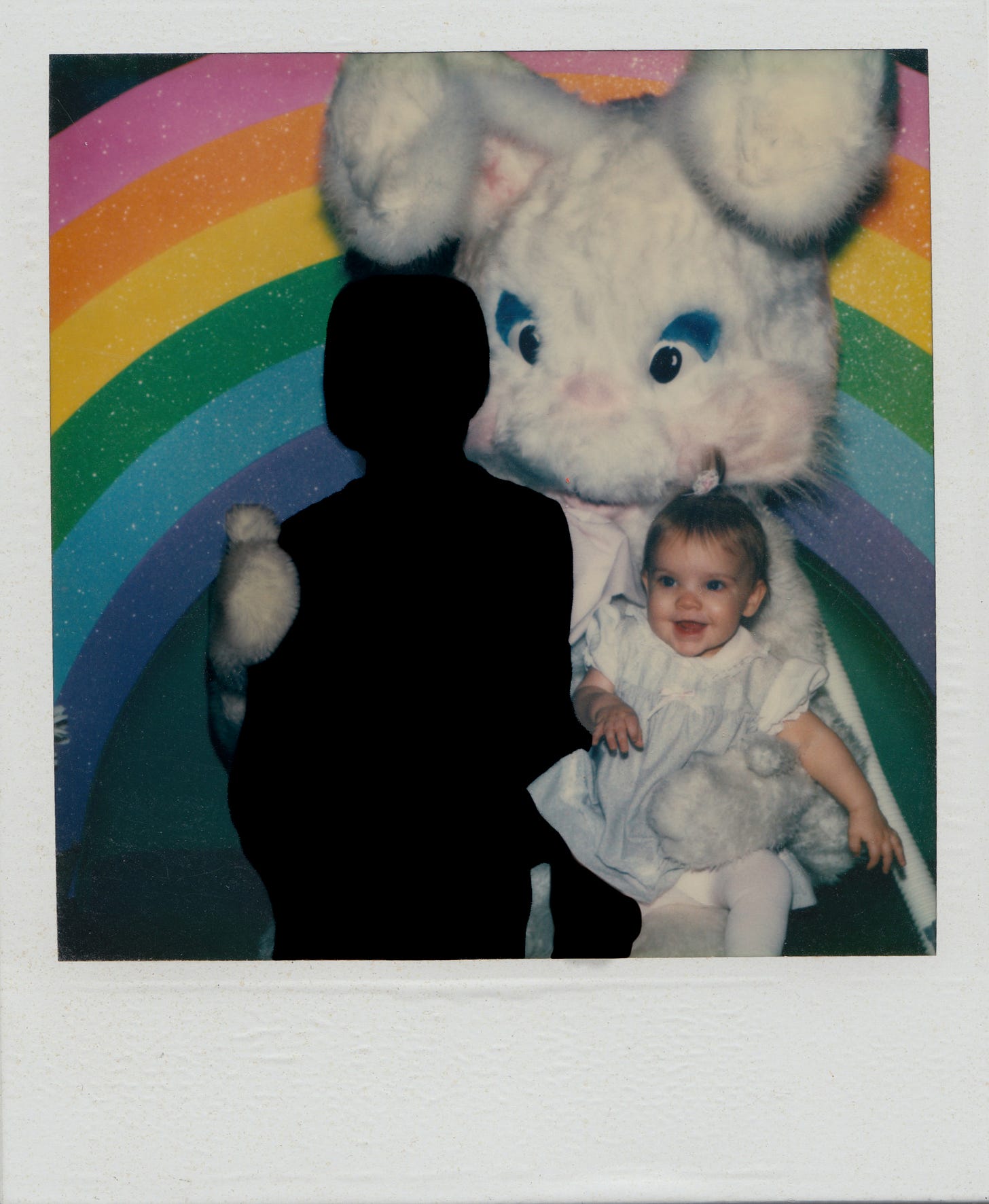 My brother and I with the Easter bunny in a Polaroid. I'm a baby and he is silhouetted black. 