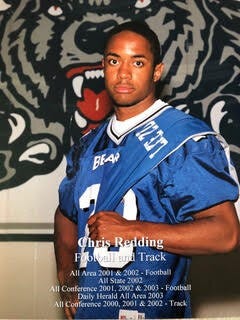 Chris wearing his high school awards.jpg