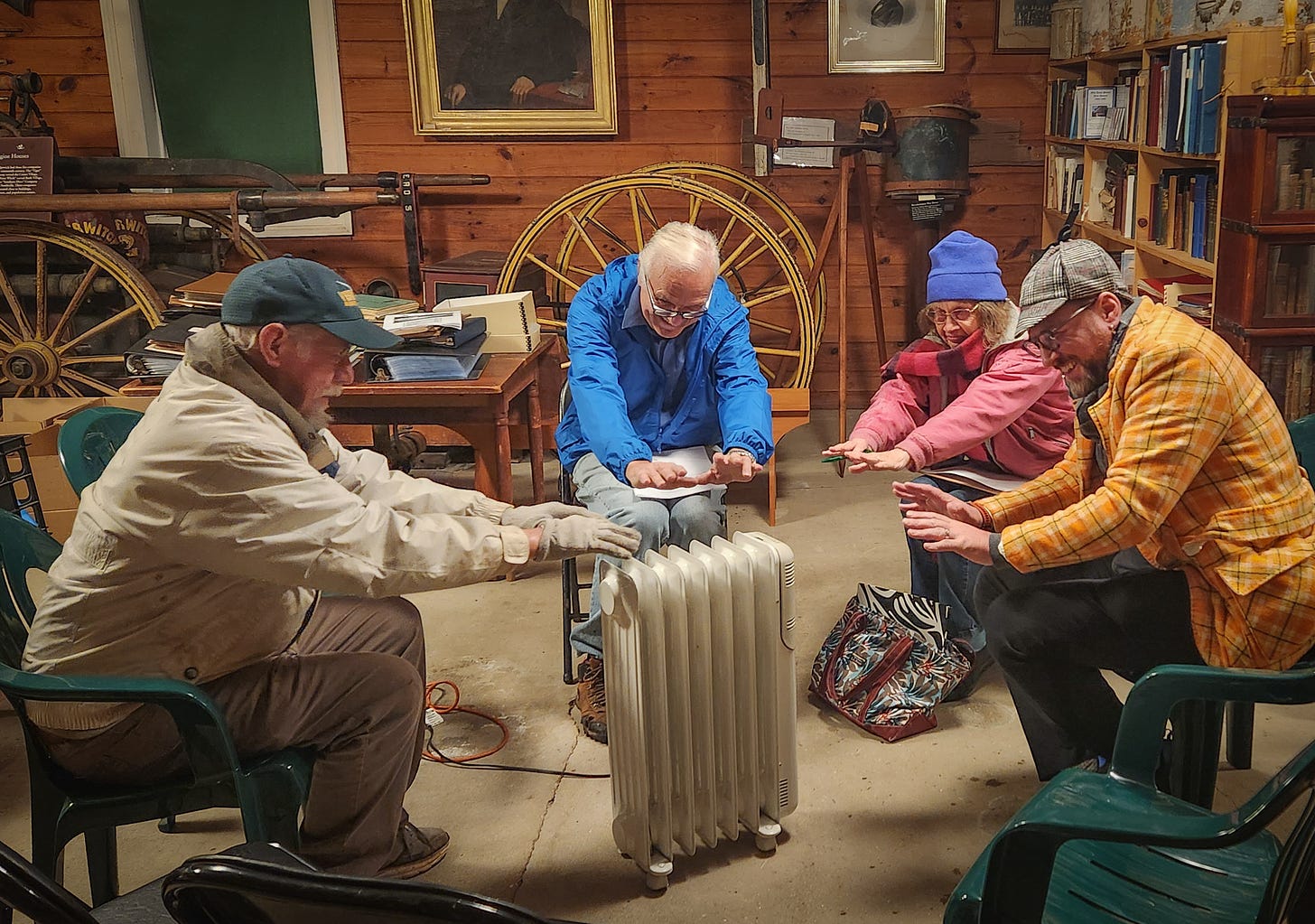 Four people warming their hands