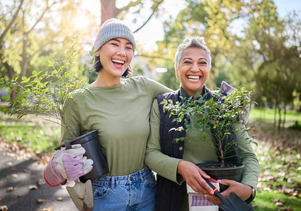 Woman volunteering in the park doing community outreach together.