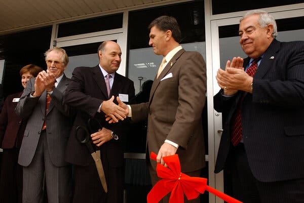 Fuad El-Hibri, third from left, the founder and executive chairman of Emergent BioSolutions, shaking hands with Robert Ehrlich, then the governor of Maryland, at an Emergent site in Frederick, Md., in 2004.