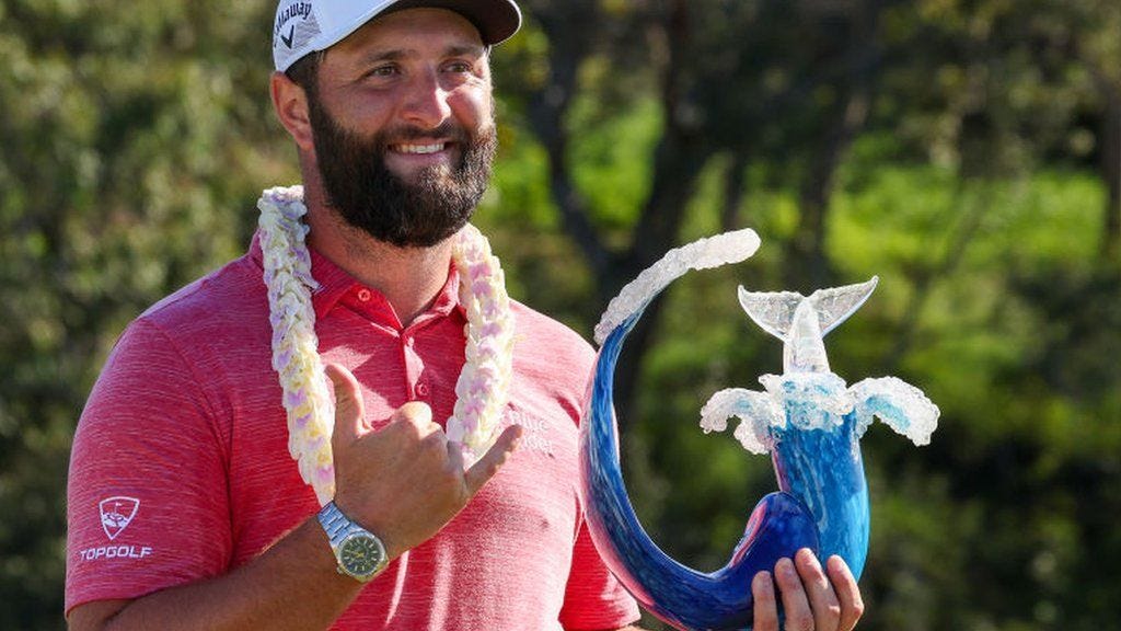 Jon Rahm with Tournament of Champions trophy after winning in Hawaii last year
