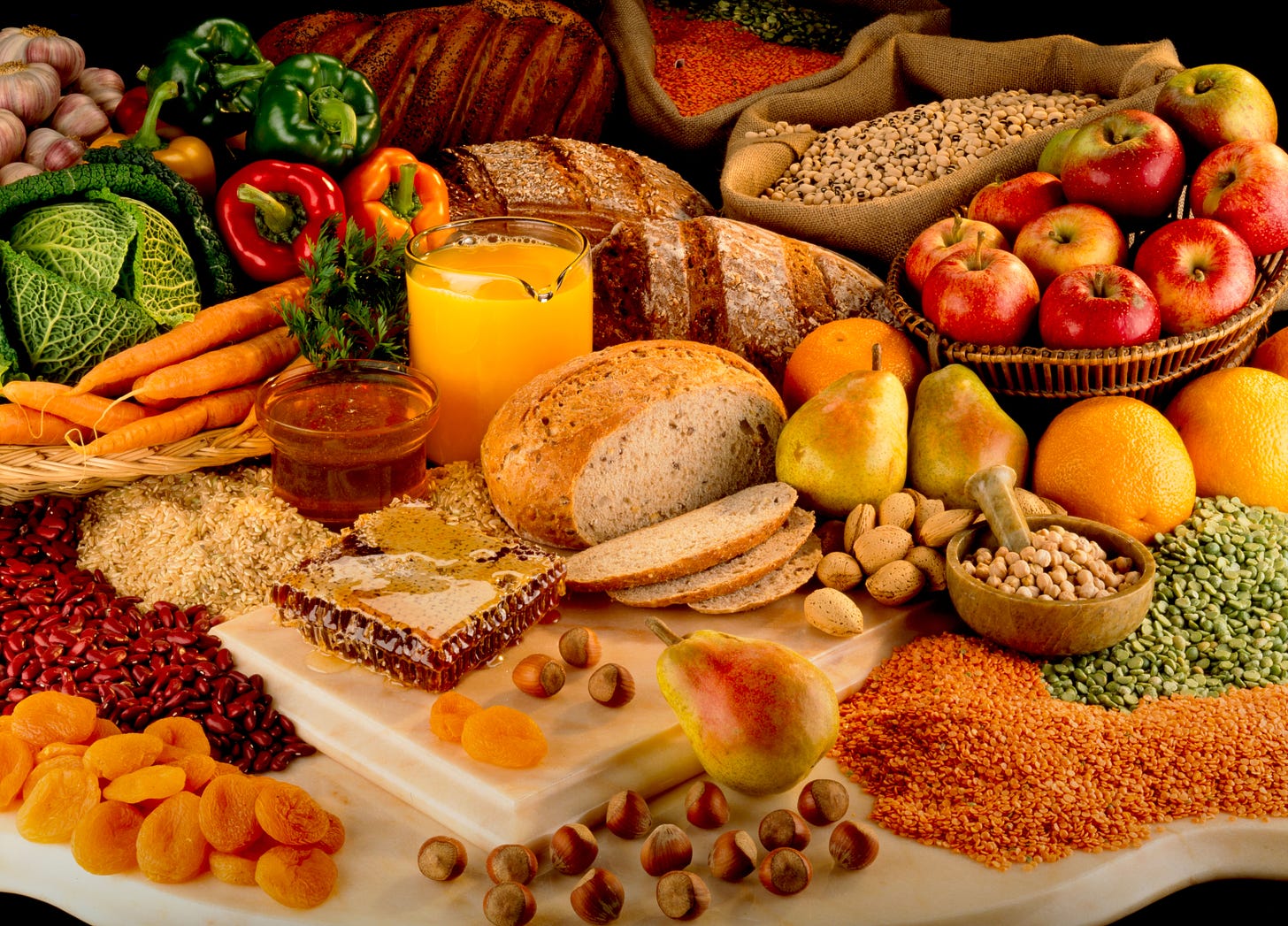 A selection of high quality fibre food including bread, fruit, nuts, legumes and grains 