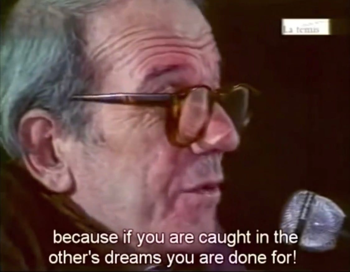 An older white man with thick rimmed glasses--Gilles Deleuze--is speaking into a microphone and there is a caption that reads Because if you are caught in the other's dreams you are done for!
