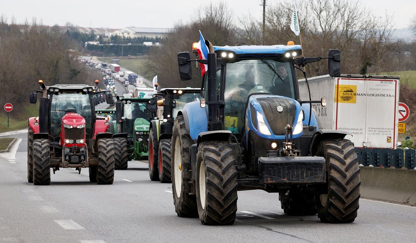 French farmers use their tractors during a go-slow operation near Roissy Charles-de-Gaulle airport as they protest over price pressures, taxes, and green regulation in Fosses, near Paris, France, January 31, 2024.  
