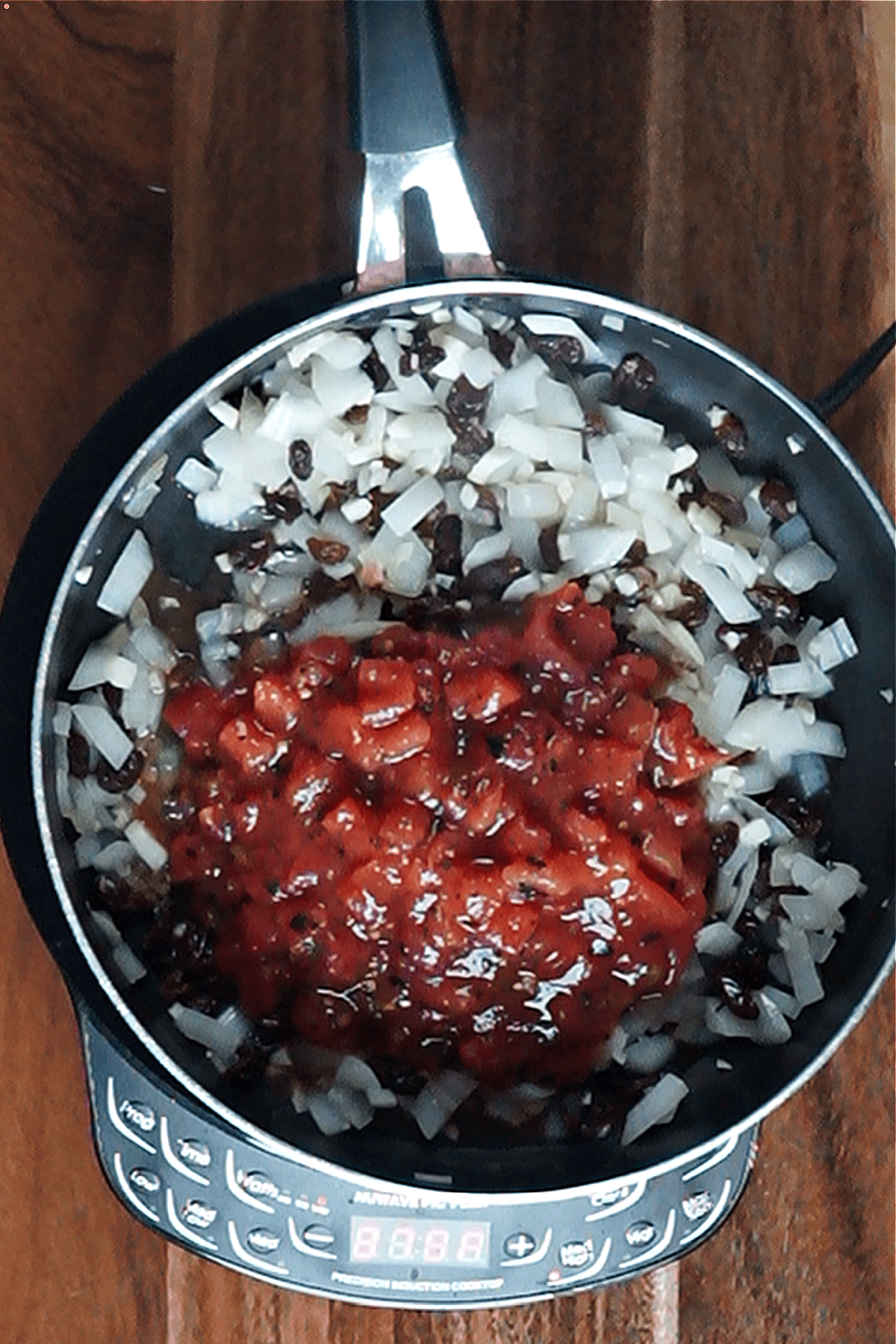 sautéing onions, garlic, raisins, and tomatoes for vegan mole