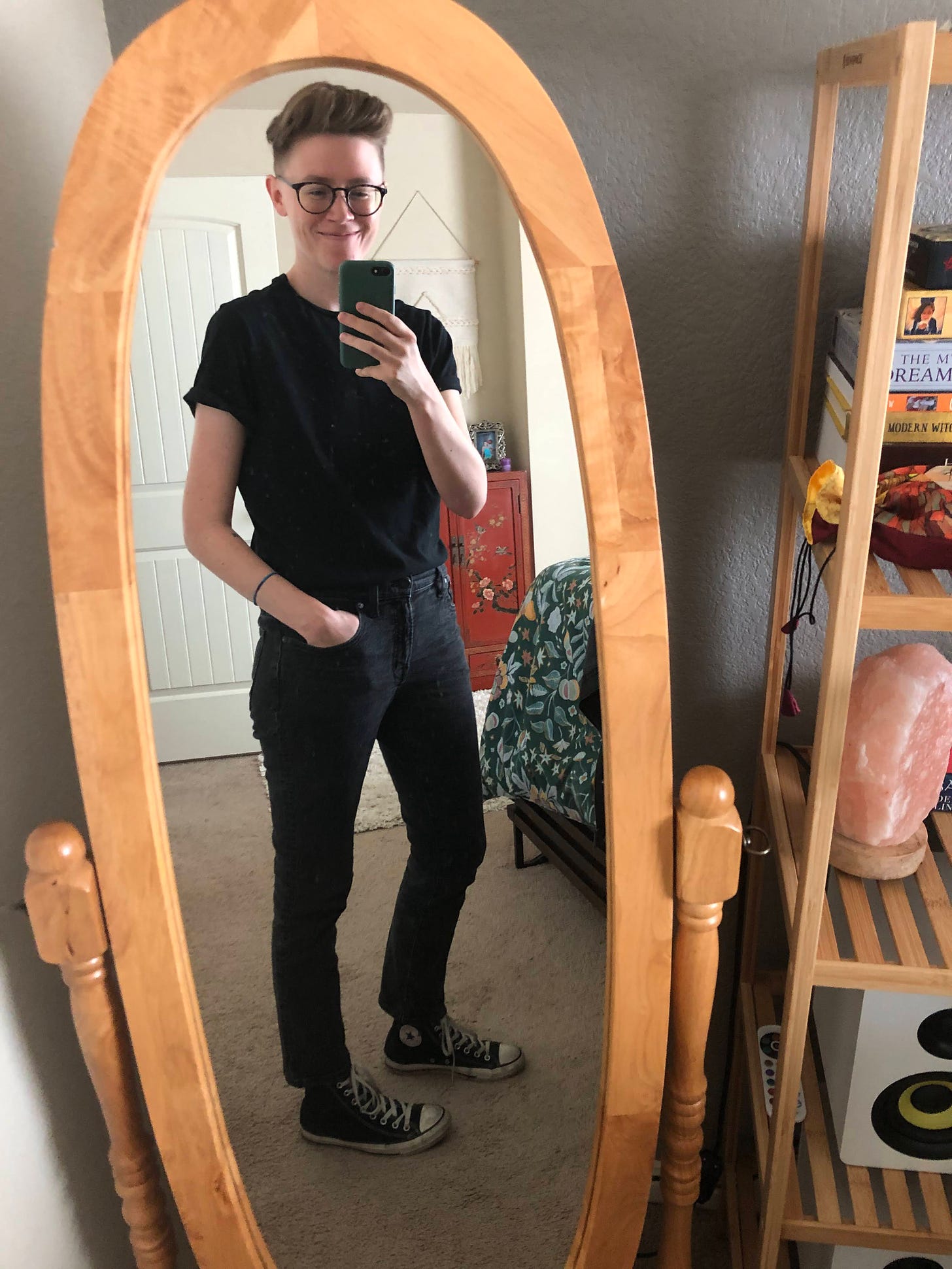 Caley in all black t-shirt, jeans, and converse.
