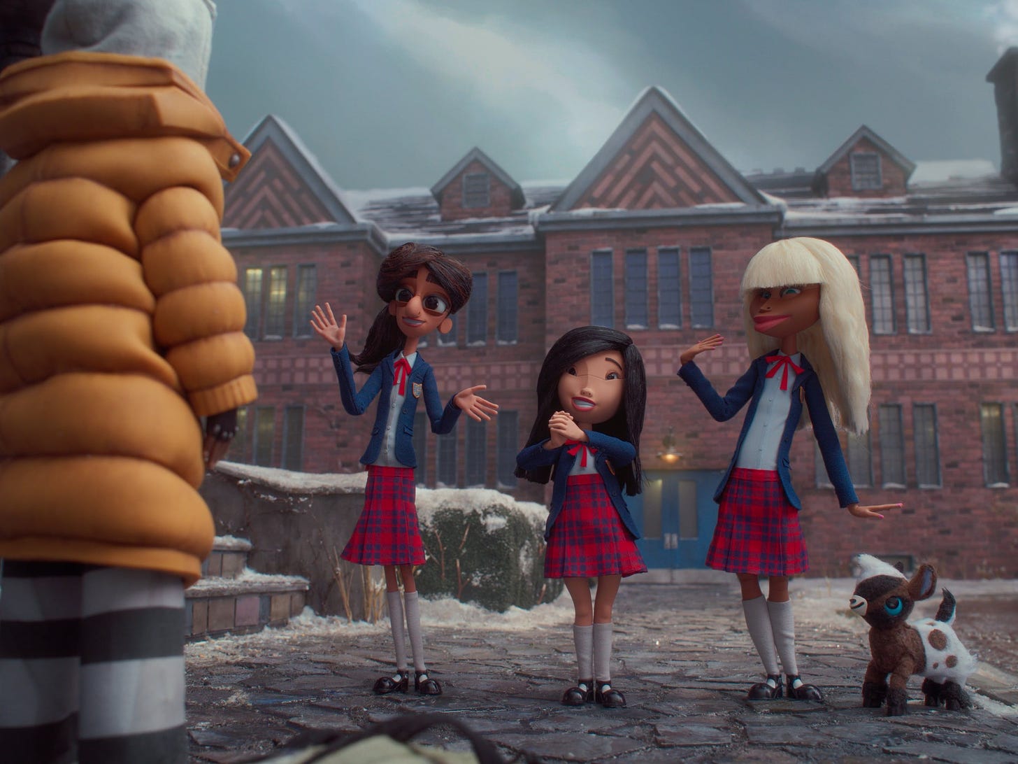 A still from Wendell & Wild, where we see Kat off to the left, facing a line of three peppy, prep-school girls, including Shiobhan on the right