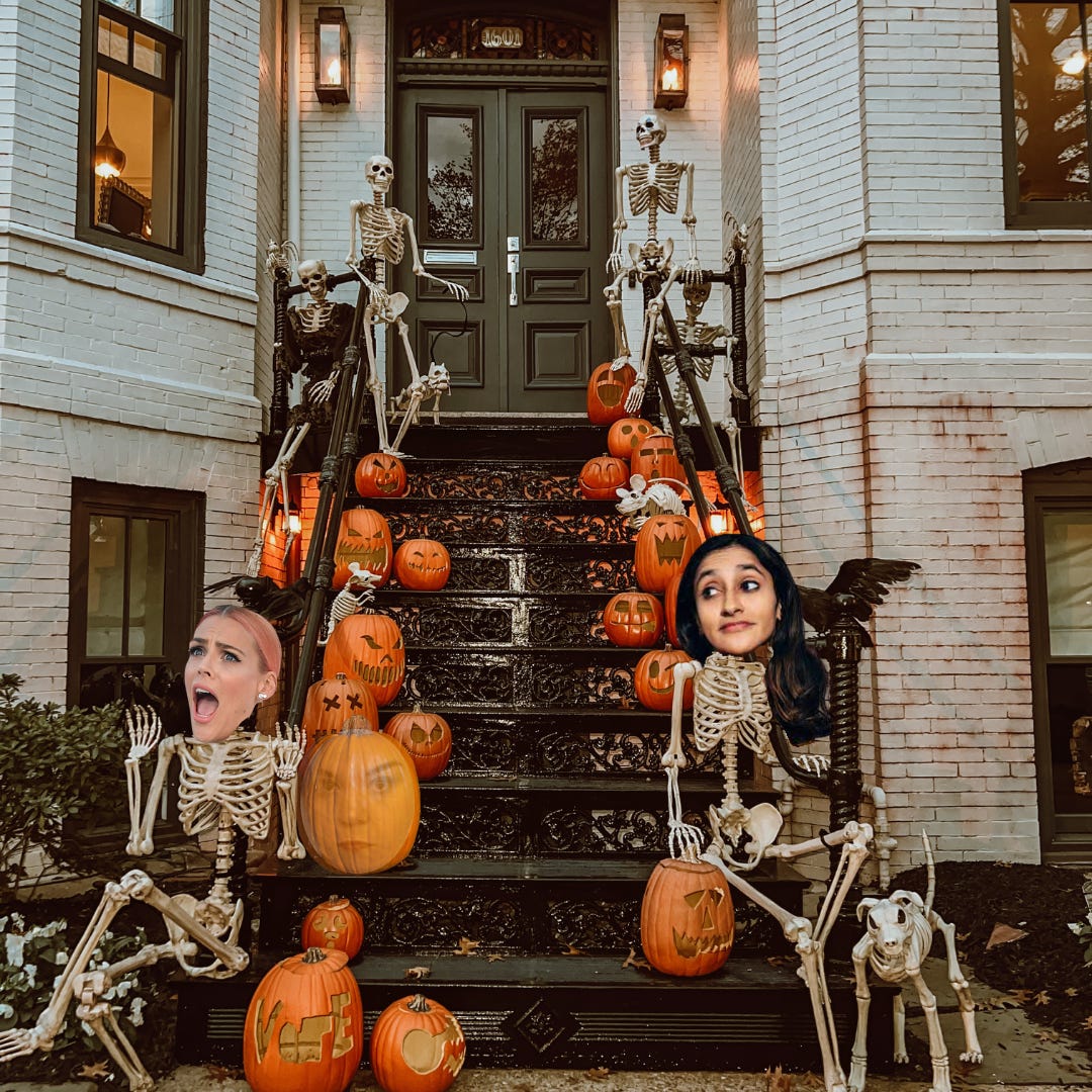 Brownstone stairs, decorated with skeletons and pumpkins for Halloween. Busy and Aparna are skeletons. Caissie is a pumpkin.