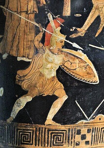 Screenshot of a color photograph of a red figure vase painting. A warrior in armor raises a spear