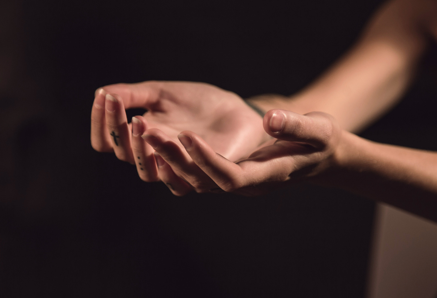 Opening yourself up, accepting. Hands are palm up in offering. [Credit: Milada Vigerova on Unsplash].