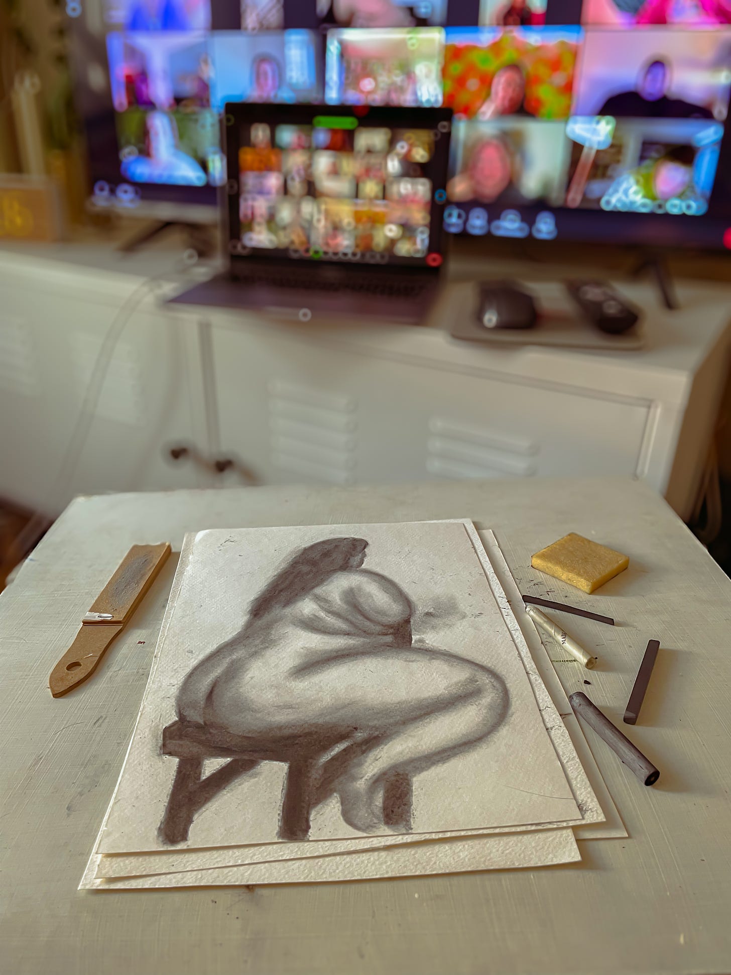 A charcoal drawing done during a lvirtual live drawing class called Fat Life Drawing, of a fat nude model with a blurred TV screen in the background showing a live zoom of other participants in the class.