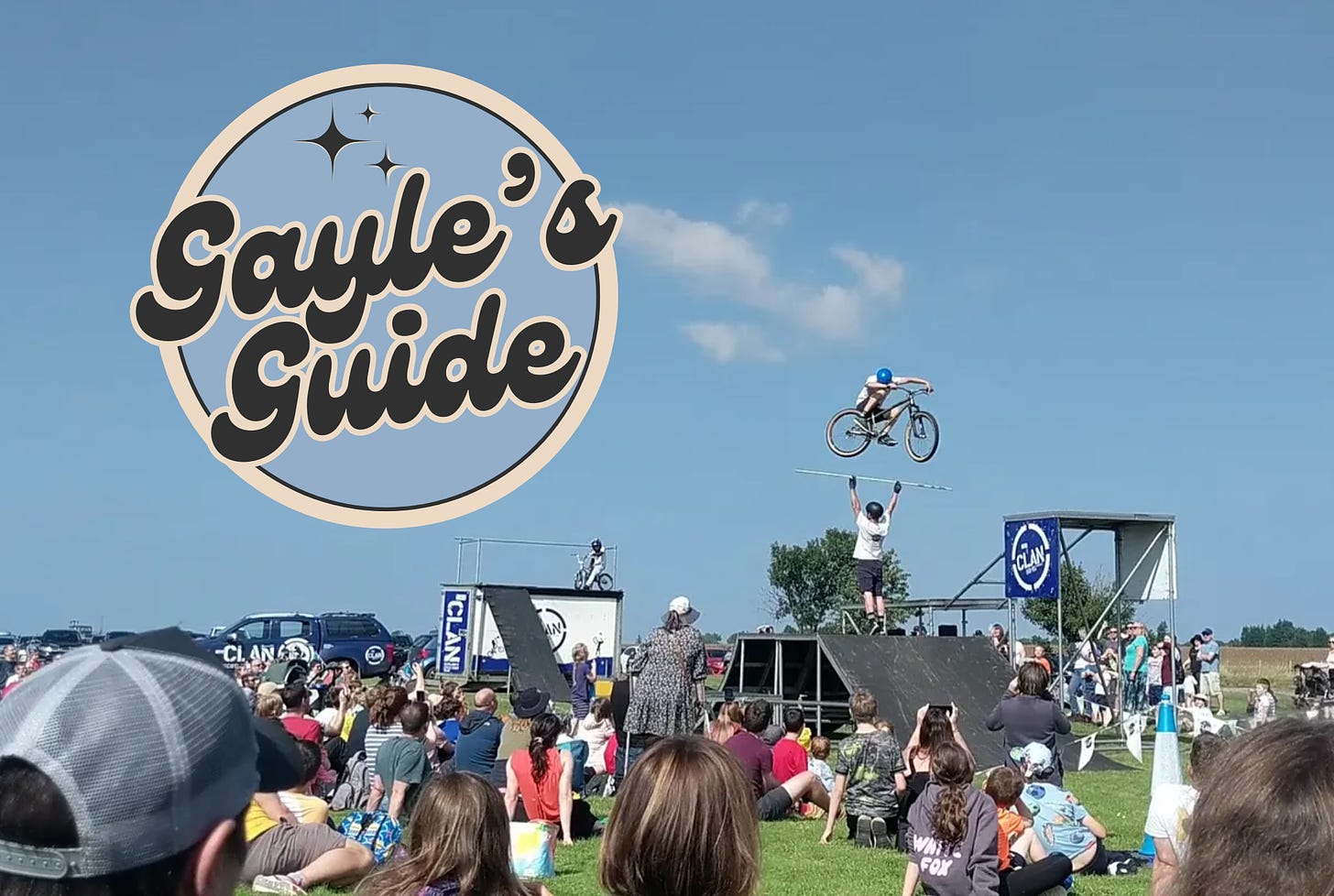 crowd watching bike stunts with Gayle's Guide logo