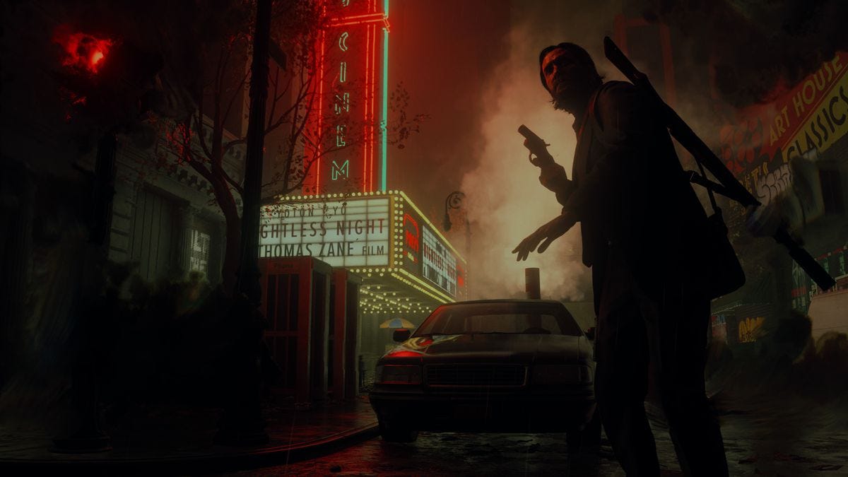 Alan Wake holding a pistol down a dark street surrounded by shadowy figures, with the neon-lit marquee sign of a movie theater visible in the background, in Alan Wake 2.