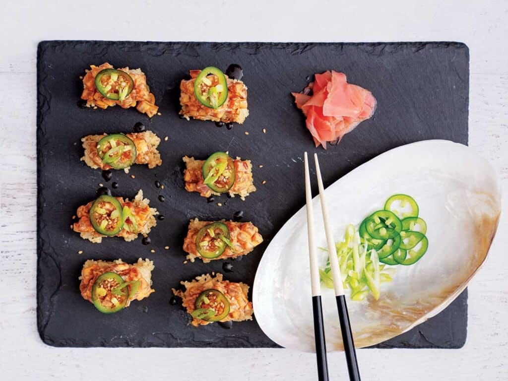 A plate of spicy tuna crispy rice, garnished with jalapeno.