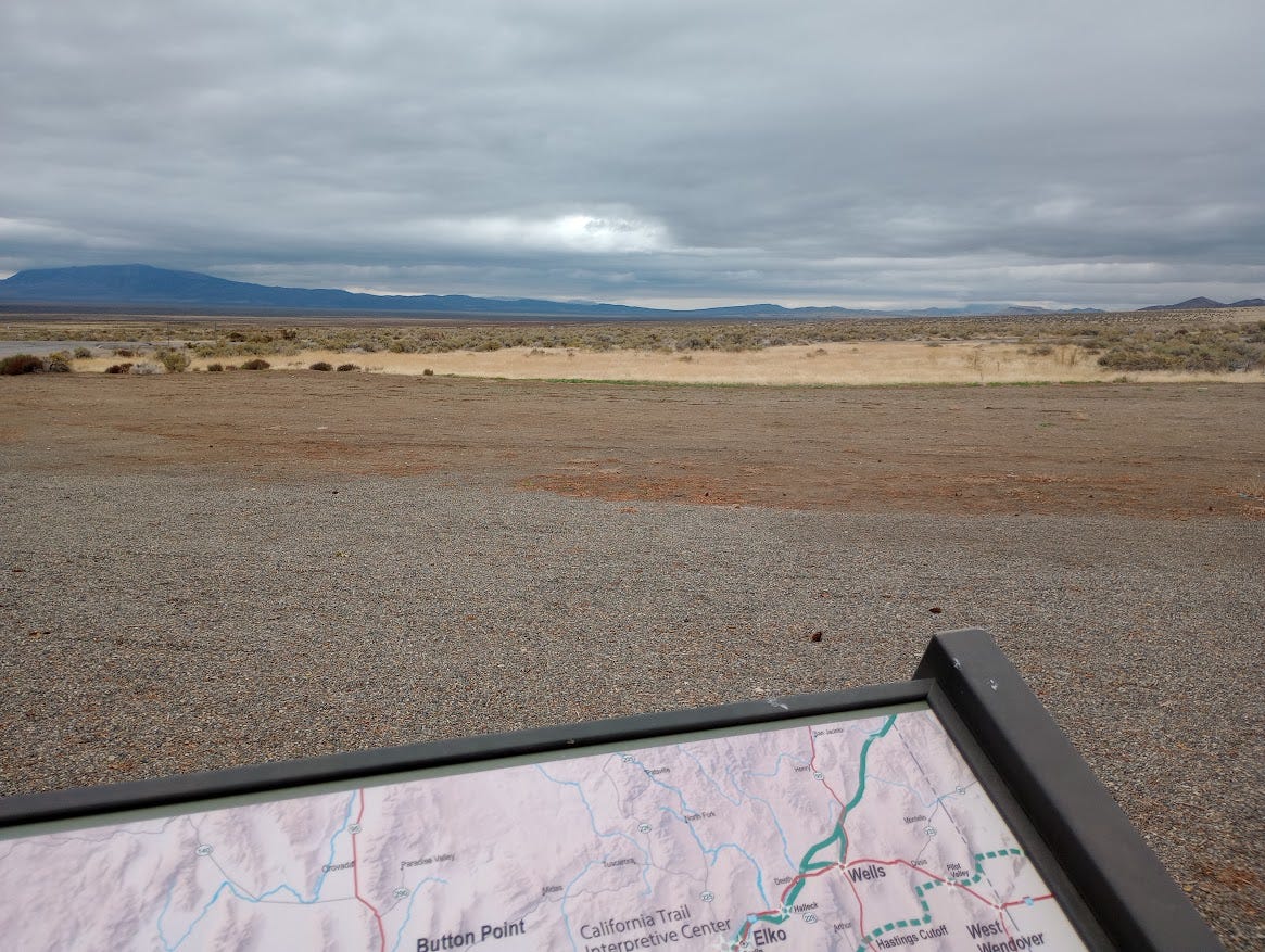 Info panel with map and view of desert and mountains under heavy clouds