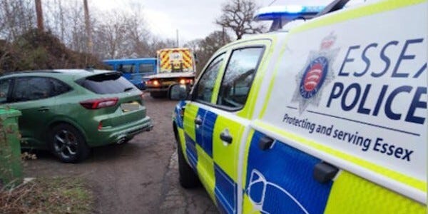Officers recovering a car containing stolen items