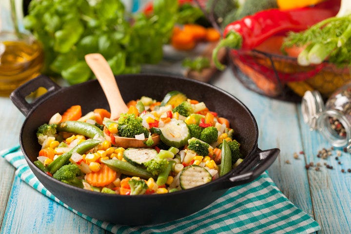 Mix of vegetables fried in a wok.