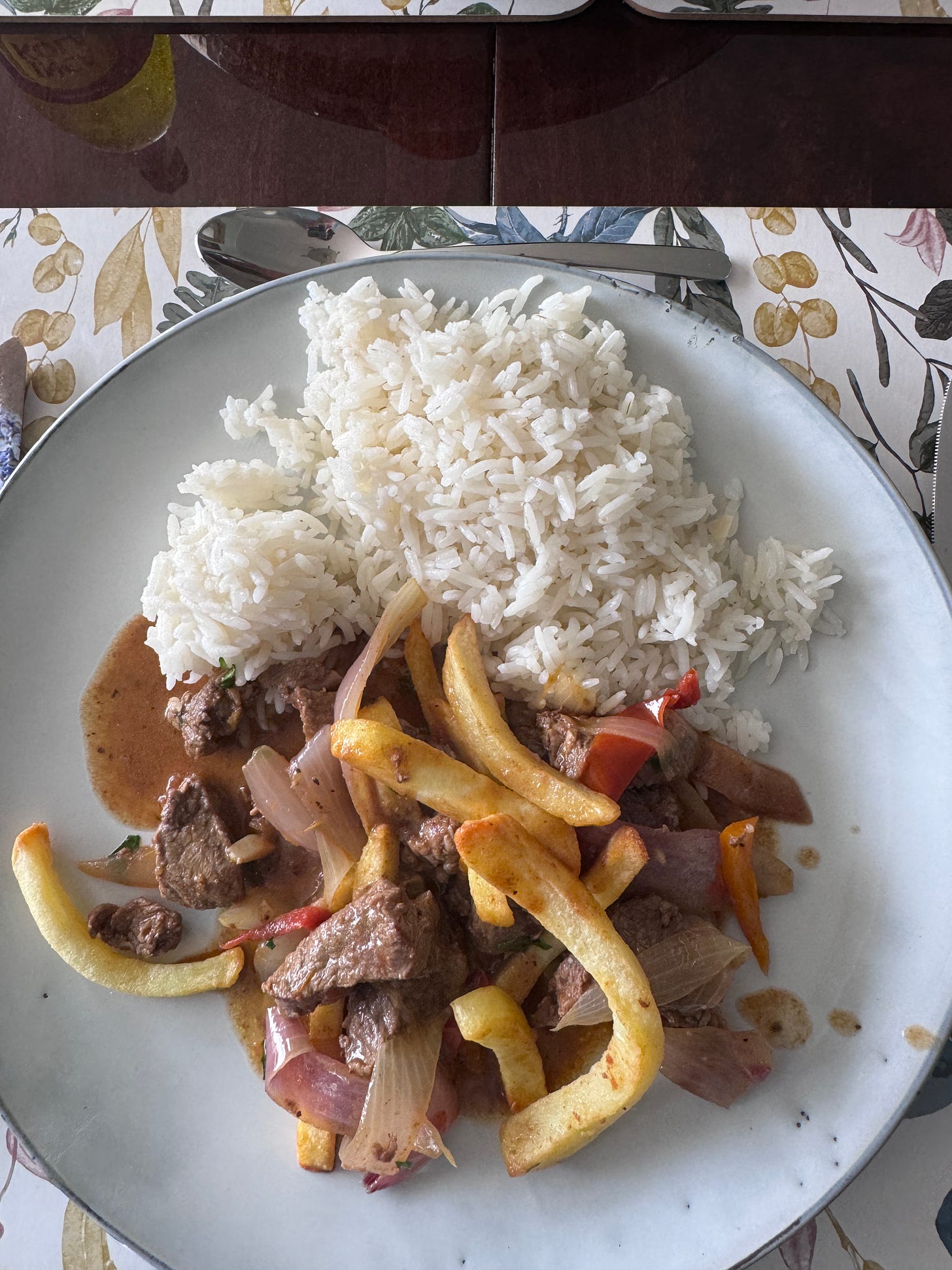 Lomo saltado and rice on a plate