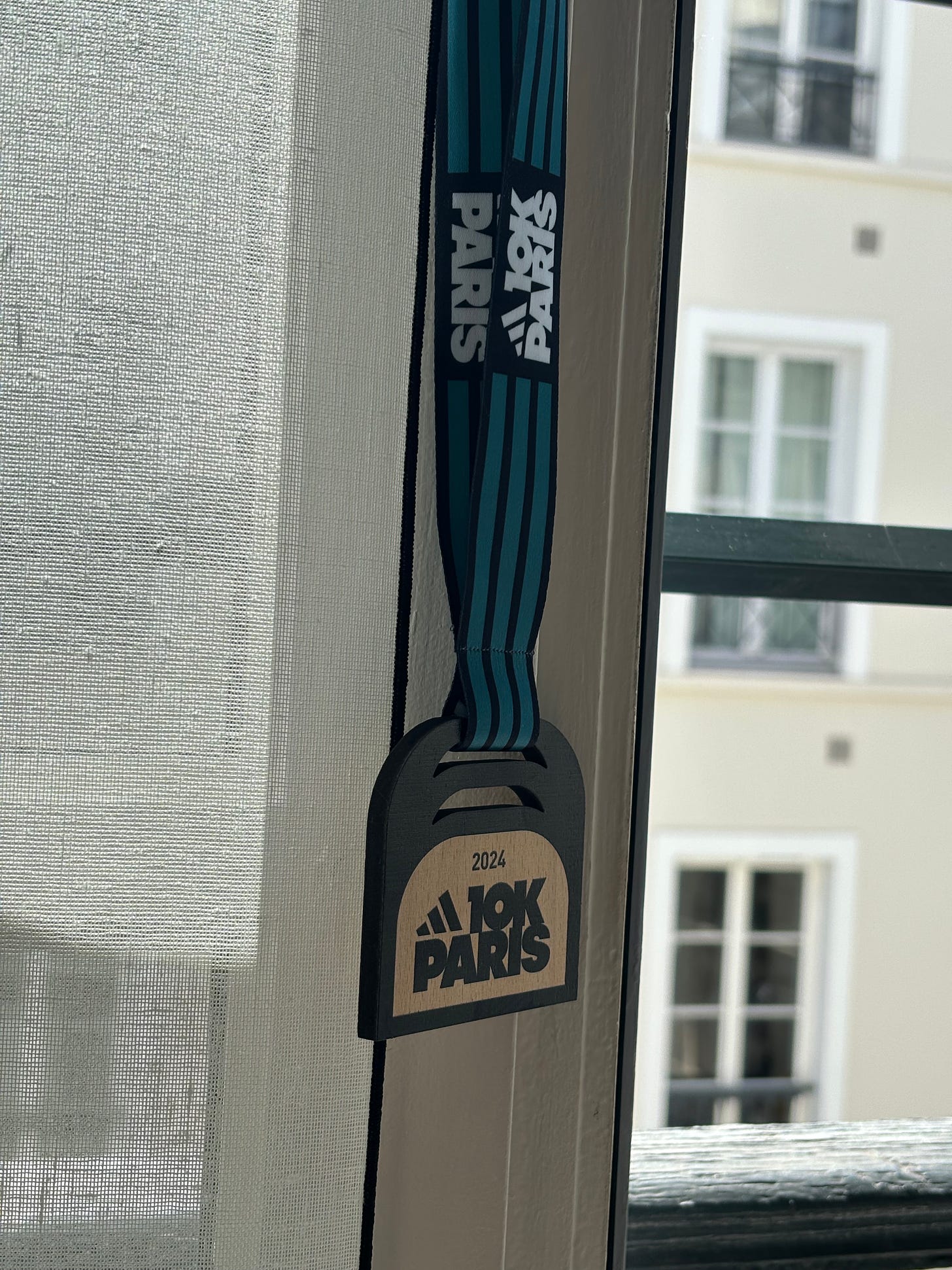 Runners at the 2024 Adidas 10K Paris received a wooden medal