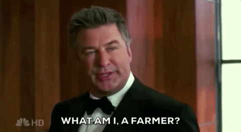 Alec Baldwin in a tux in an iconic scene from 30 Rock asking, "What am I, a farmer?"