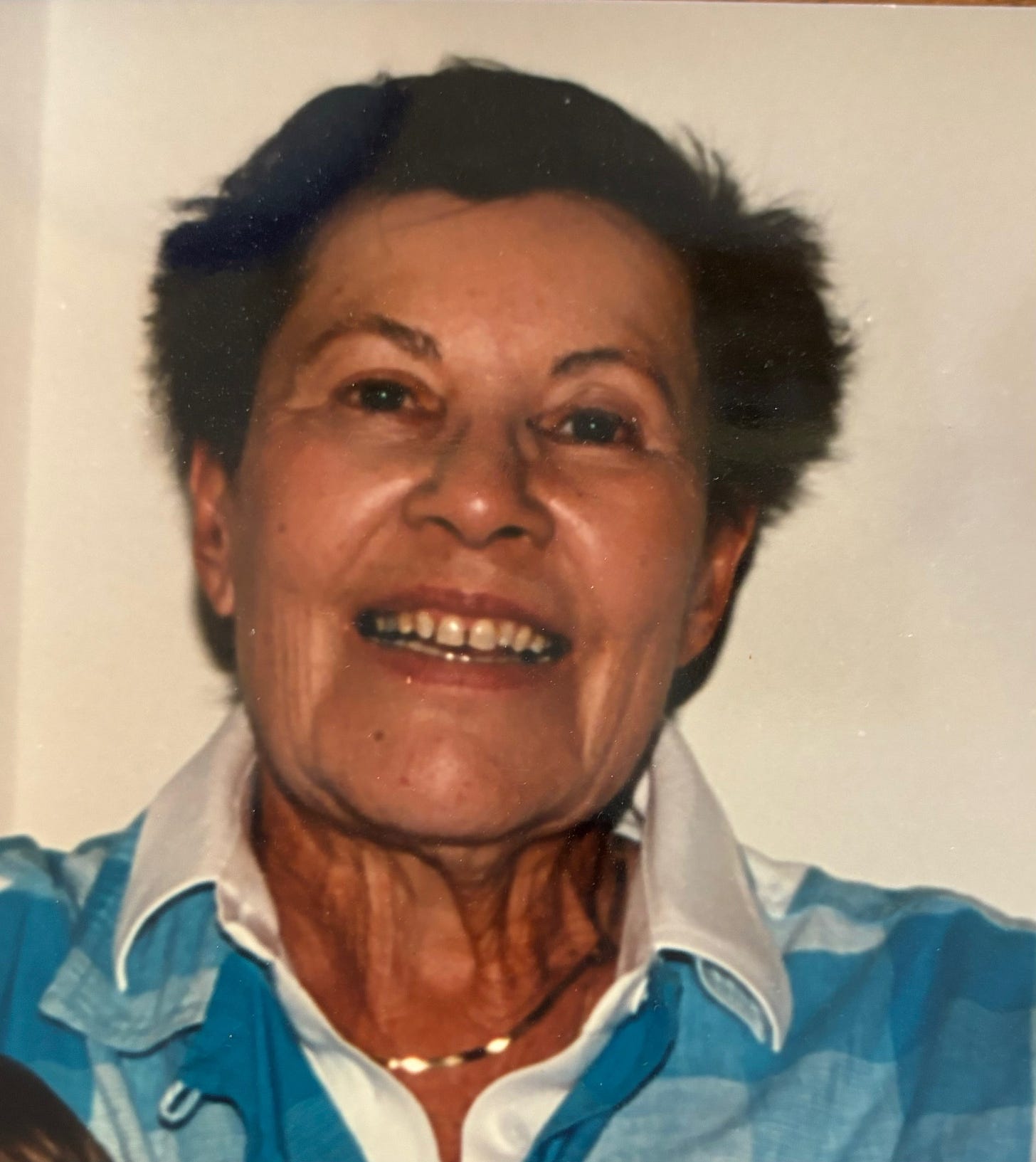 Photo of Etta Levy: She has short brown hair, and smiles at the camera