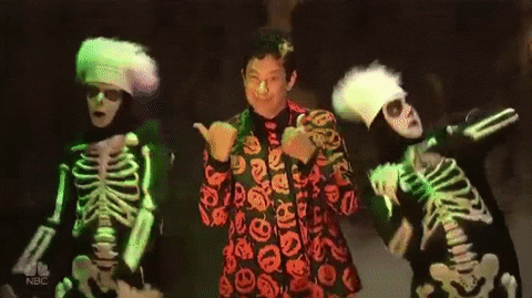 Gif of David S Pumpkins with two dancing skeletons next to him.