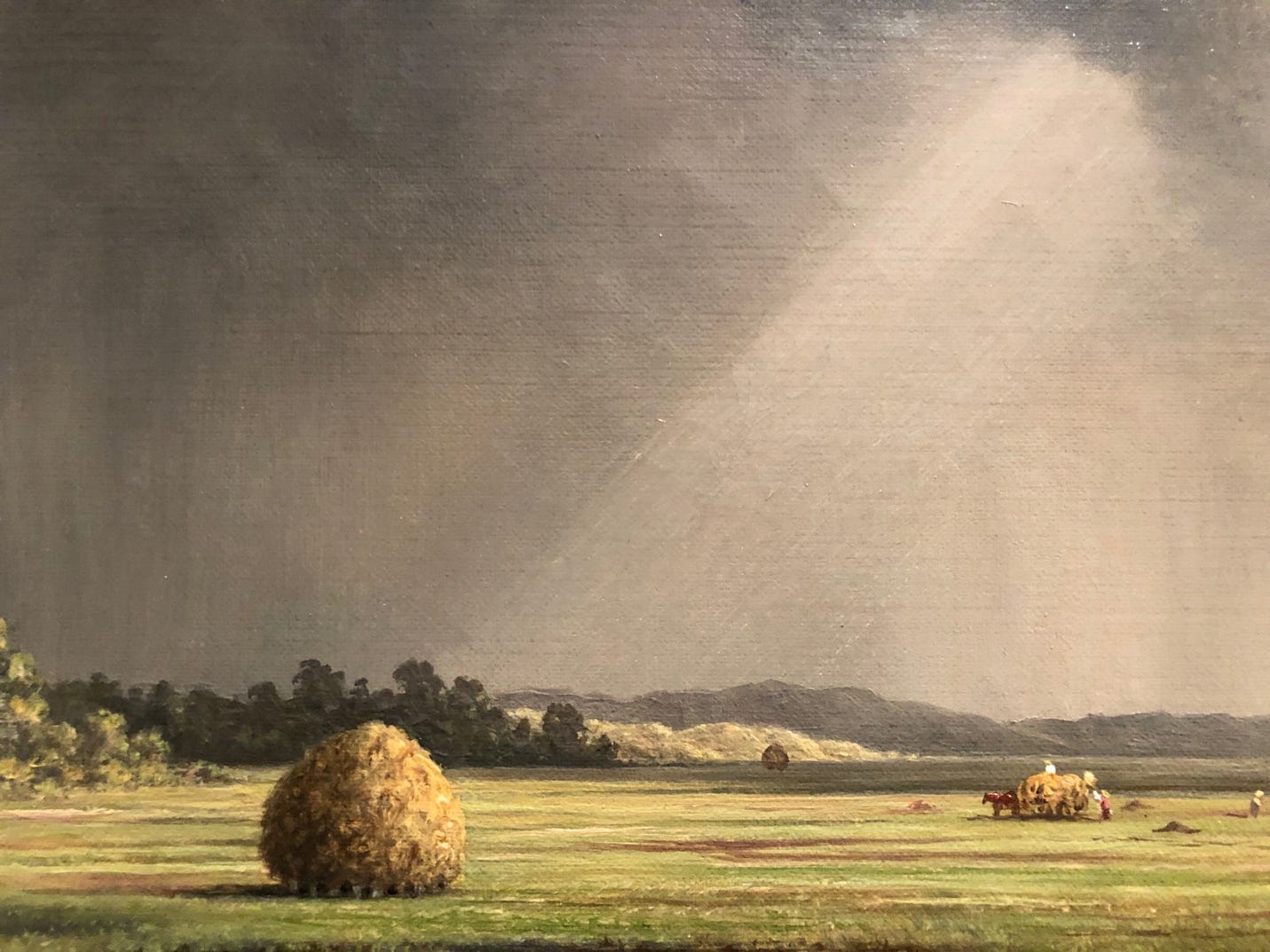 A painting of a field with hay bales

Description automatically generated