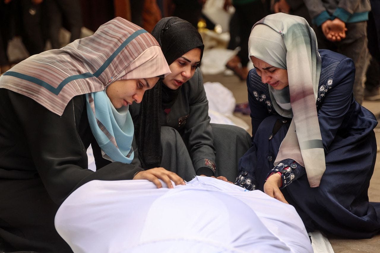 Women cry over the body of a loved one killed in Israeli strikes in Gaza City the previous night outside the morgue at Al-Ahli Baptist Hospital on Thursday.