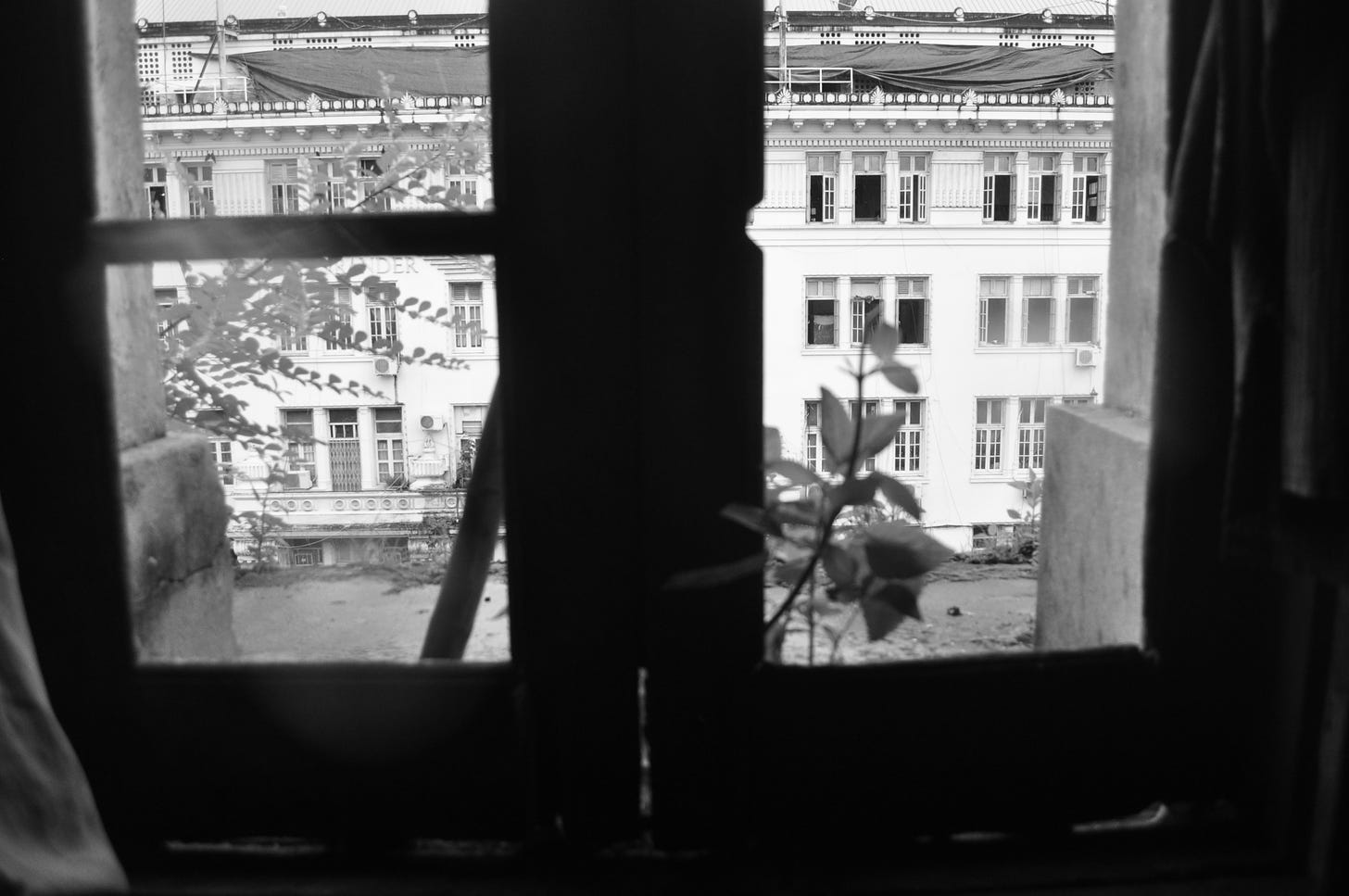 Black and white shot through a window looking out on the street in Yangon.