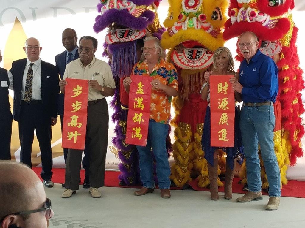 Adelanto Councilmen Charley Glasper, John “Bug” Woodard, Misty & Mayor Rich Kerr hold the ceremonial banner presented by Chinese dancers.