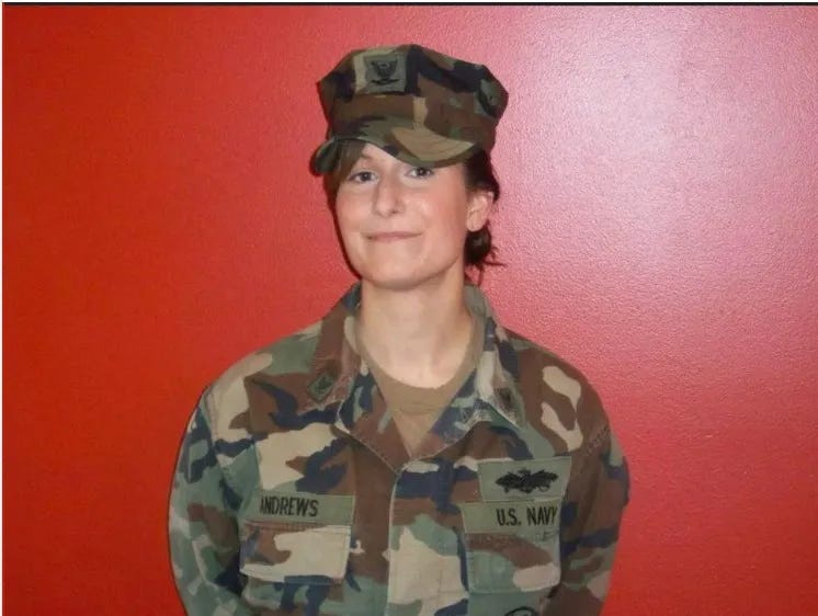 Young woman in Navy fatigues smiling and proud. Hire a veteran