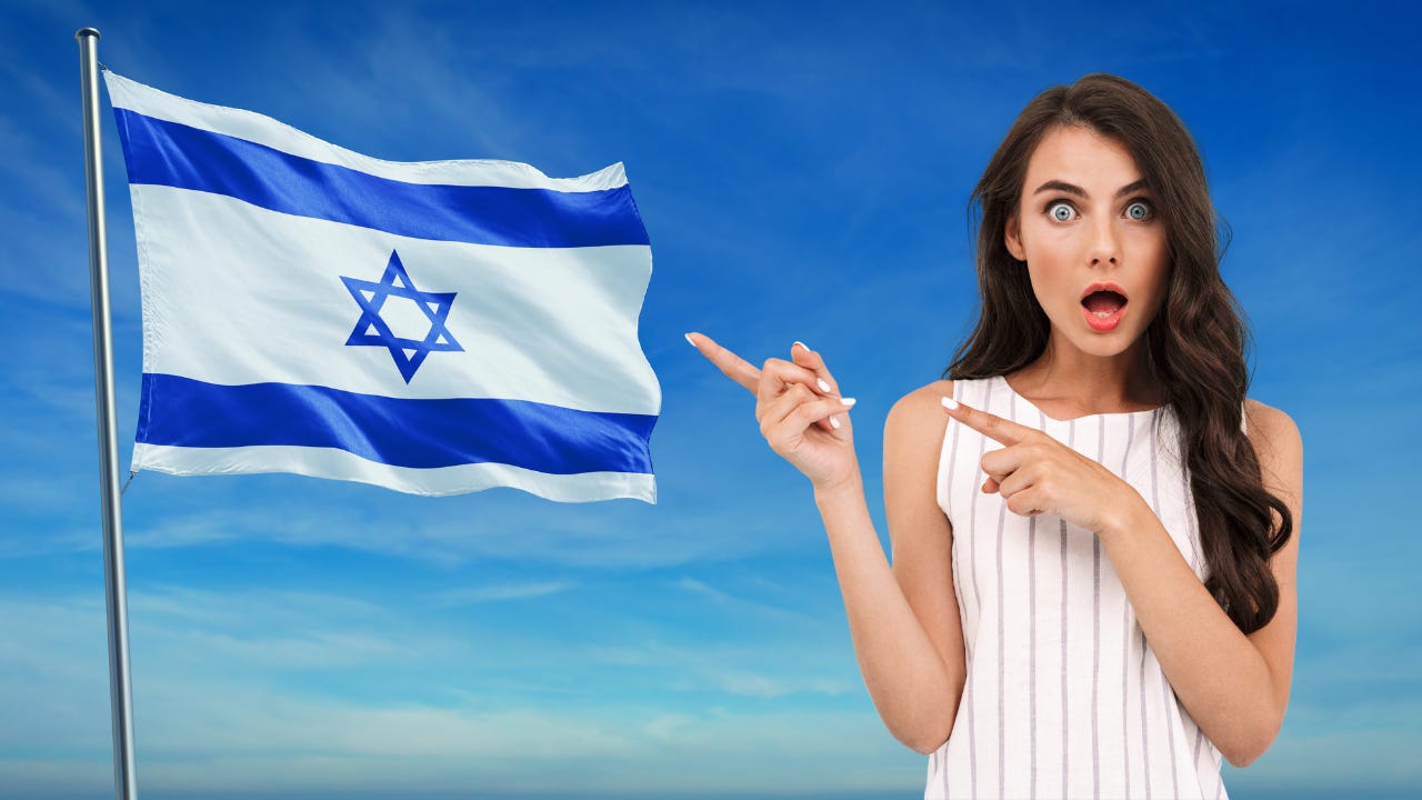 A woman looking shocked next to Israel's flag.