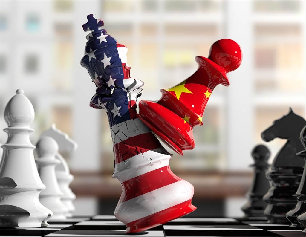 An intense chessboard scene captures a pivotal moment: China's pawn strikes, shattering America's king into pieces. This powerful image symbolizes the strategic tug-of-war between the US and China, where every move is a play for dominance in the global arena, and the stakes are the pillars of international order.