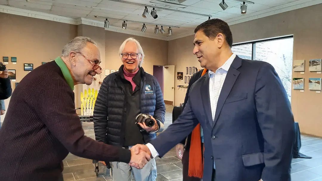 Adirondack Council Executive Director Raul Aguirre, right, greets Senator Chuck Schumer recently at the Lake Placid Center for the Arts