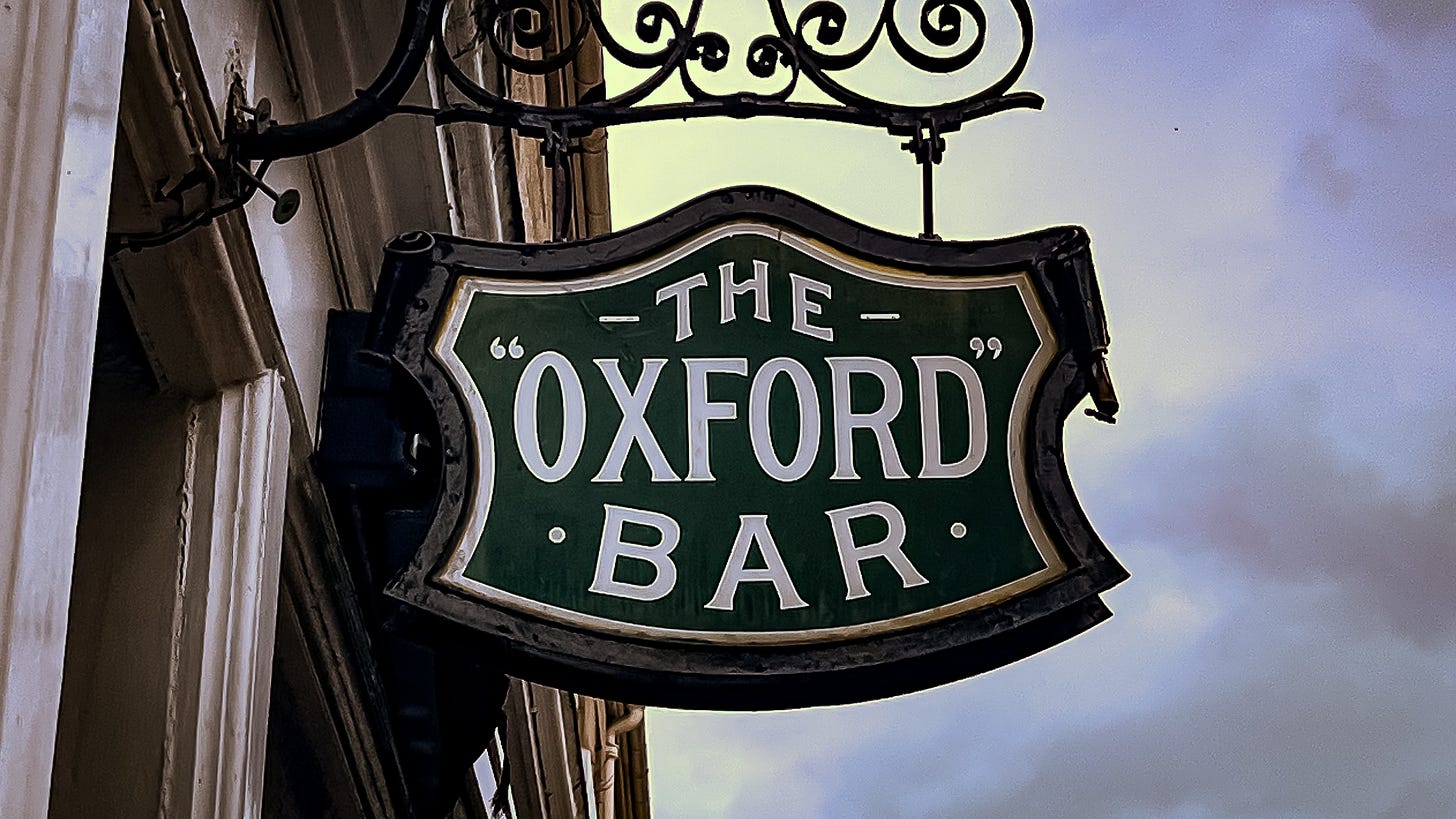 The sig of The "Oxford" Bar, white writing on a dark green background