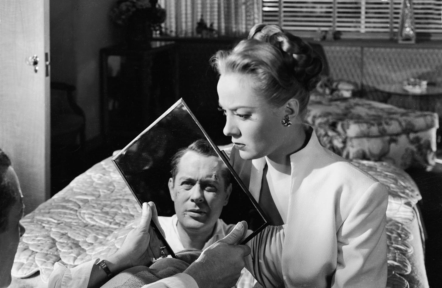 Audrey Totter looks at Robert Montgomer's reflection in "Lady in the Lake" (1947)