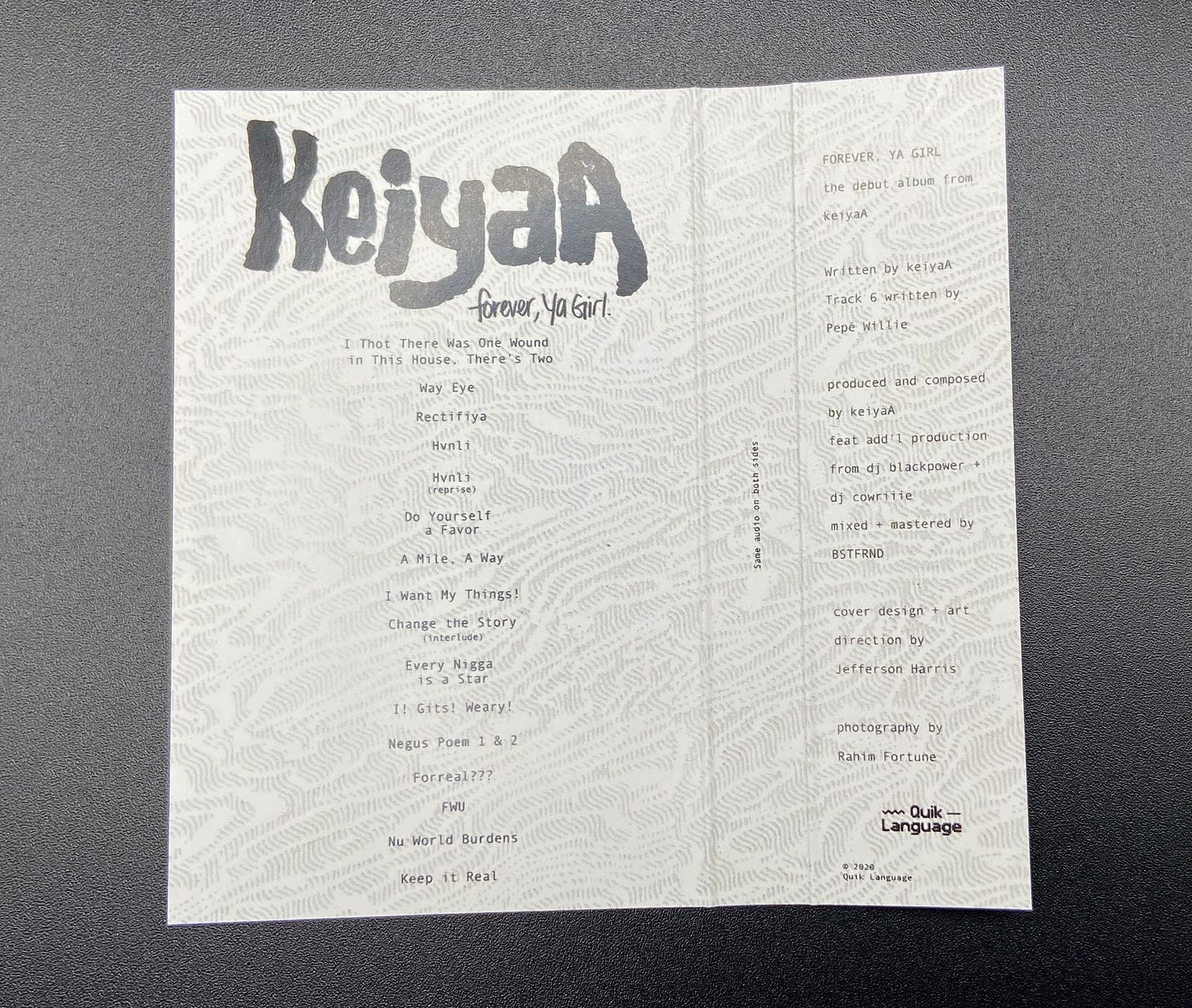 the j-card for keiyaA’s Forever, Ya Girl lays flat with the liner notes and tracklist visible.