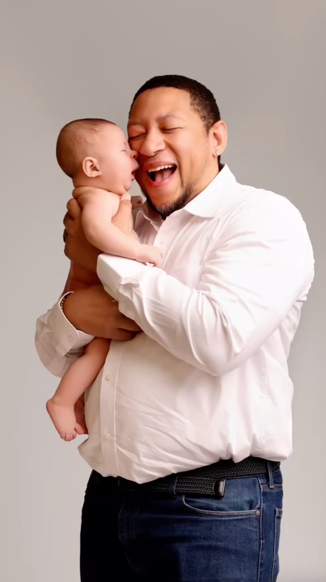 Chef Nelson German, Dominican-American man, holds his baby son