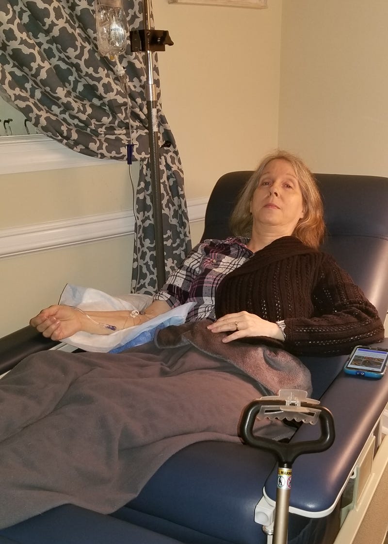Woman reclined getting IV fluids