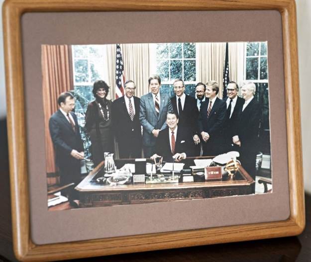 A group of people in a frame

Description automatically generated