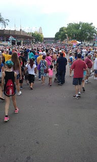 A large space of pavement before the huge crowd of people at the minnesota state fair.