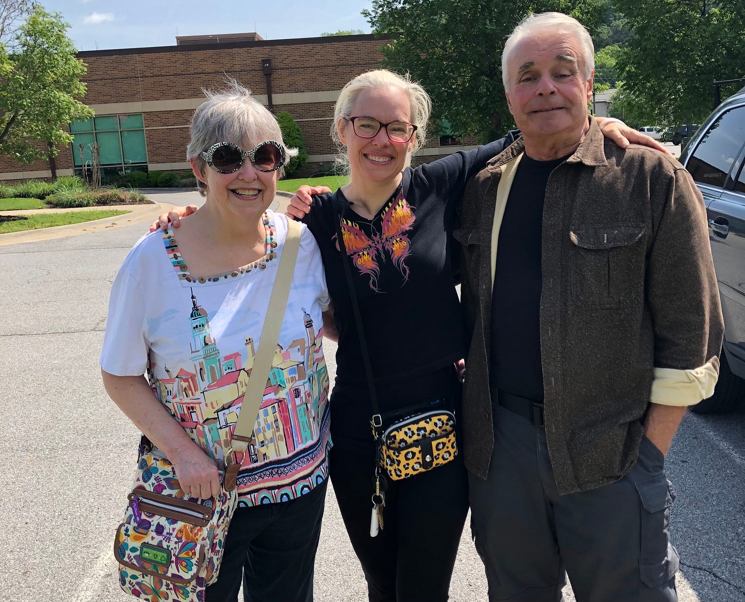 The author with her arms around the shoulders of both her parents.