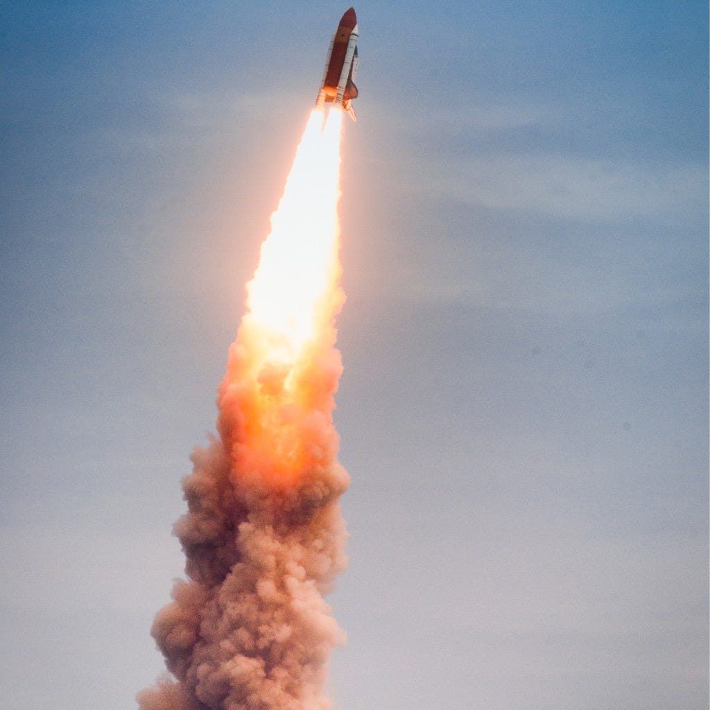 Condensation trail behind the Space Shuttle made up of water droplets.